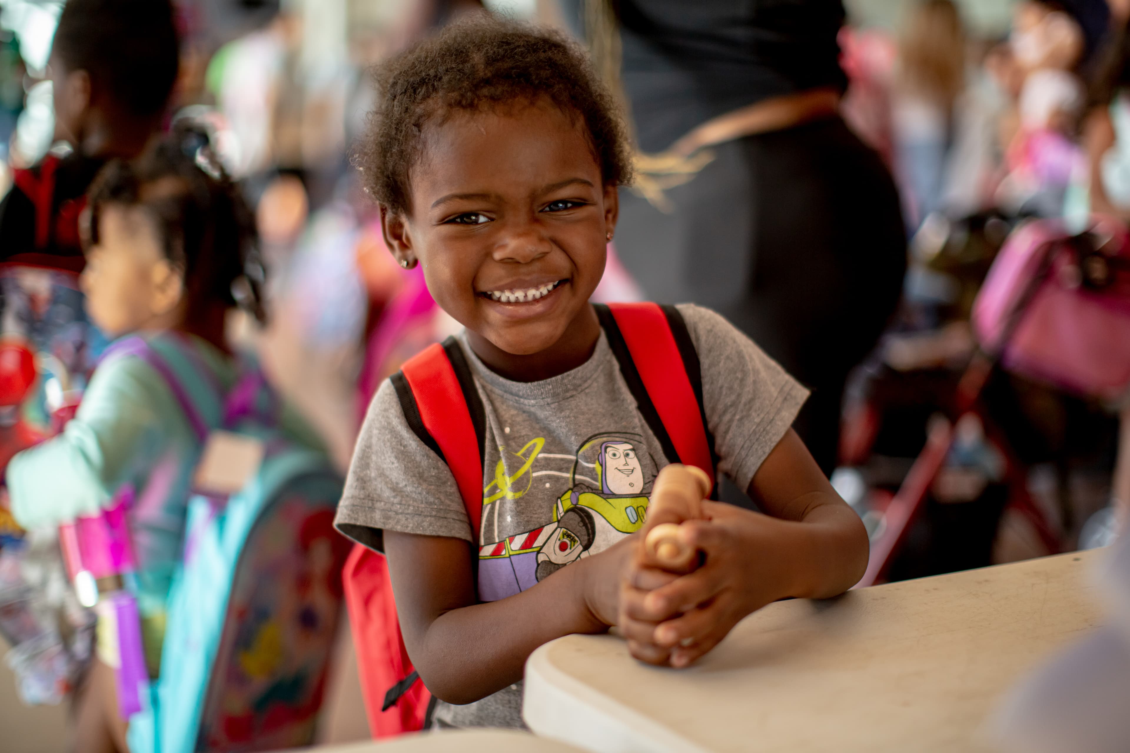 Students receiving backpacks at a Packz 4 Kidz event