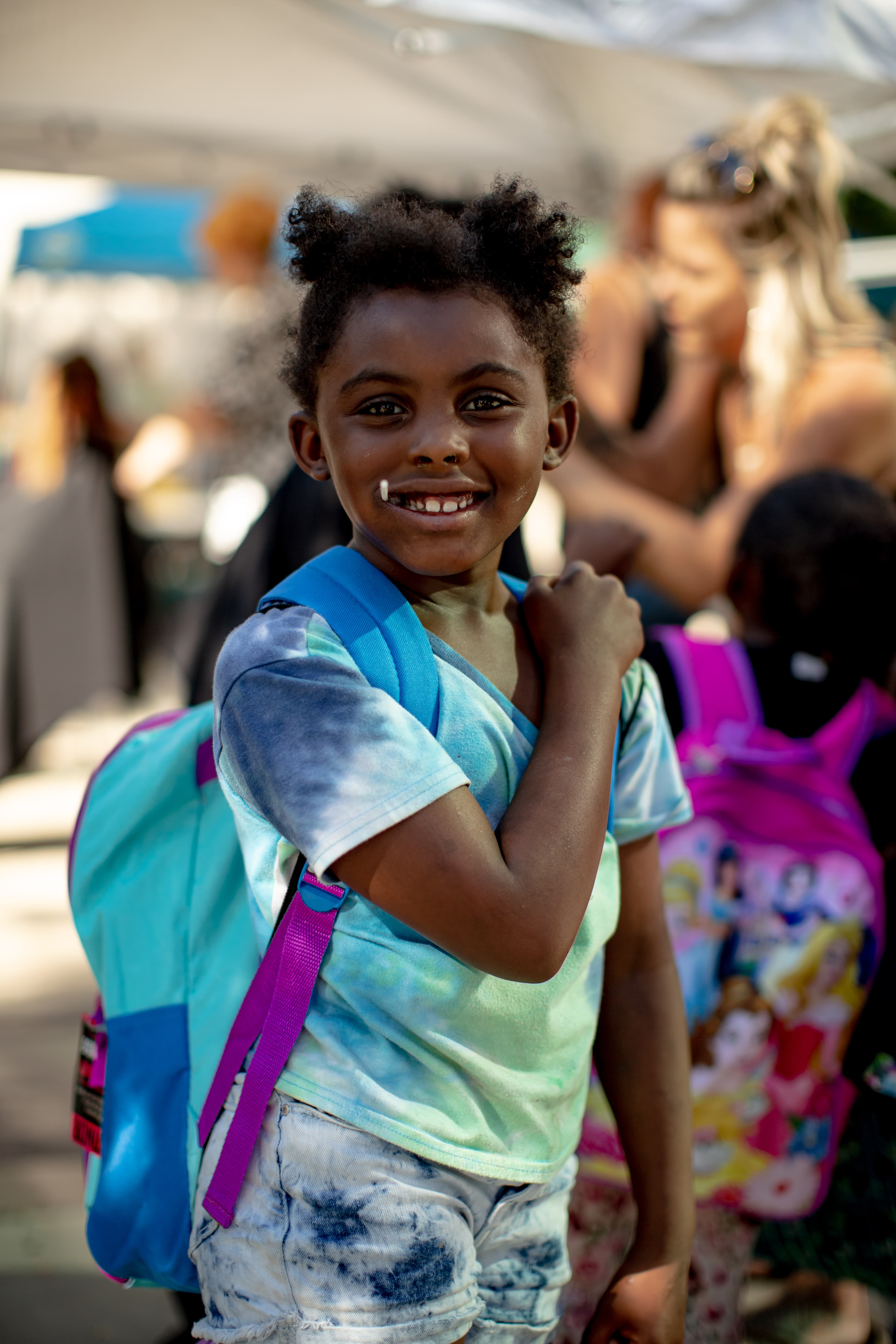 Volunteers handing out school supplies