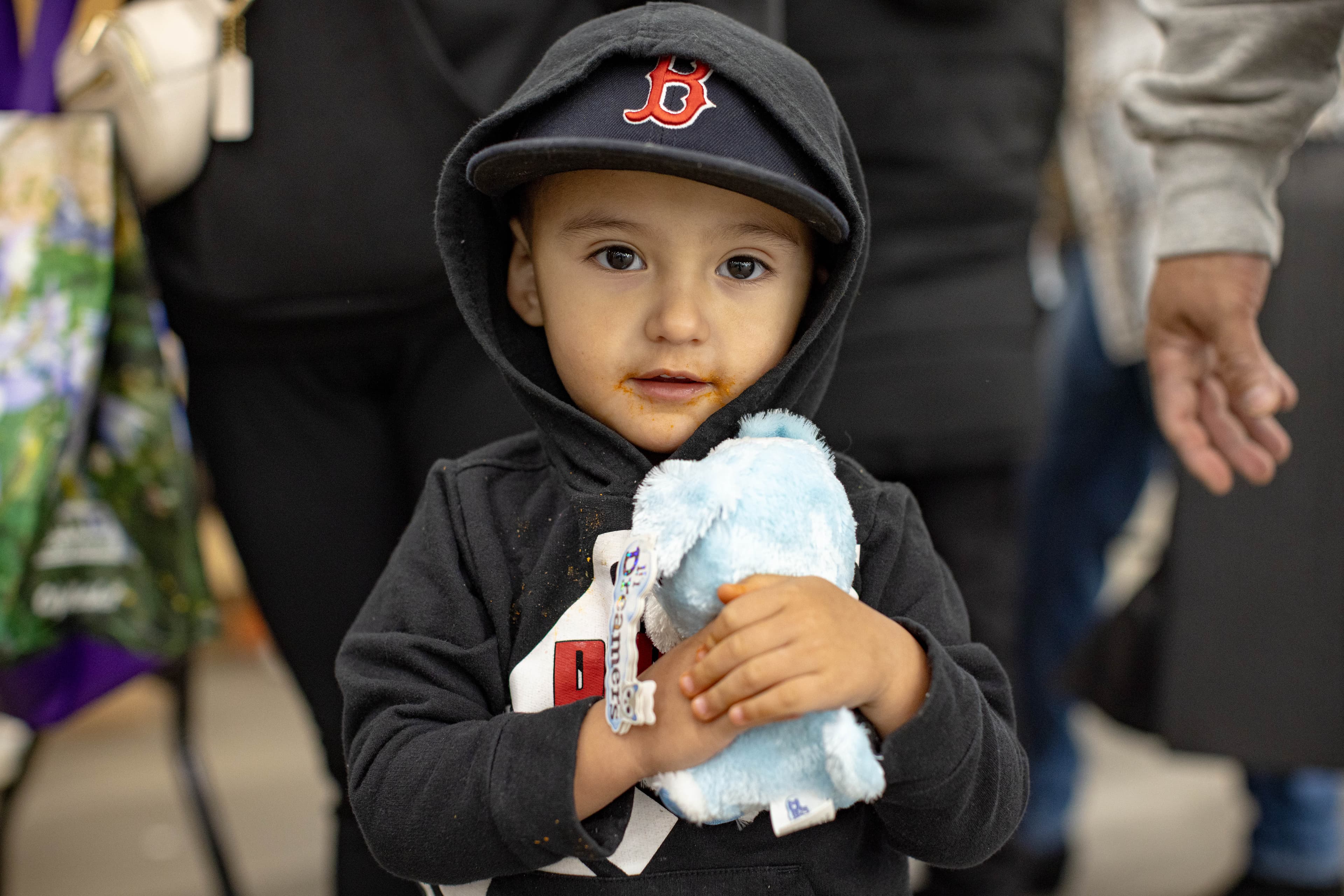 A toddler clutching his brand-new stuffed animal